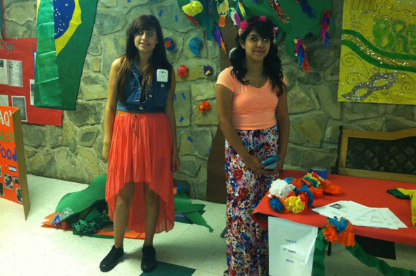 2 students smiling standing in decorated hallway