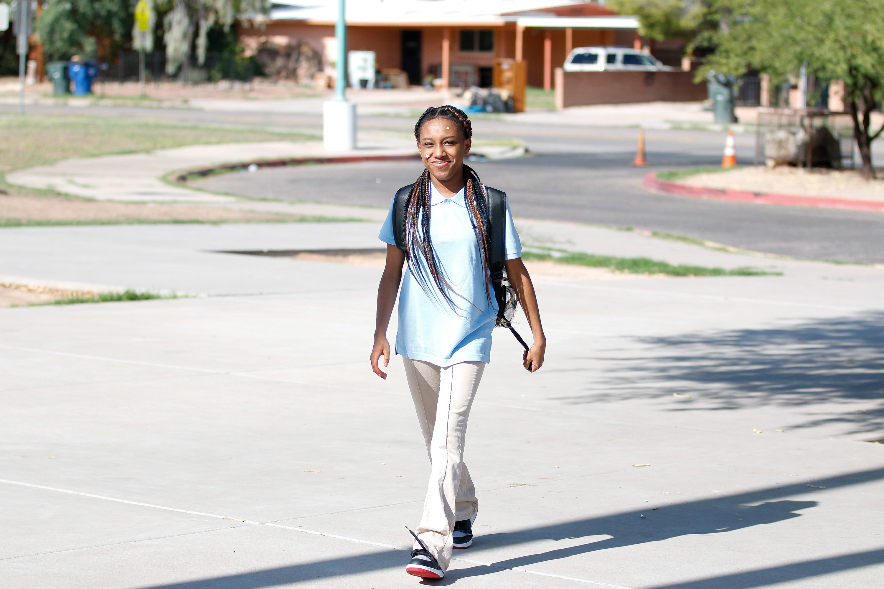 A middle school girl walks to school on the second day