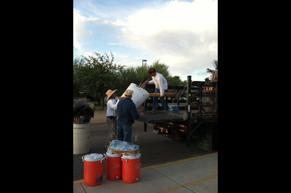 Men unload supplies off of a truck