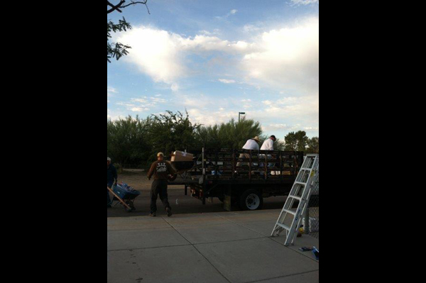 Men unload supplies from truck