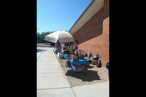 Tables set up outside of school with supplies on them