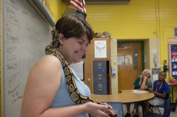 Teacher holding a snake 