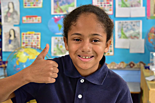 Student giving a thumbs up and smiling