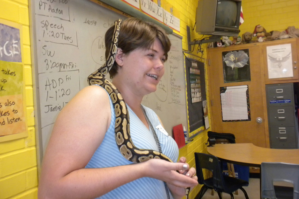 Snake on teachers shoulder and head as she laughs
