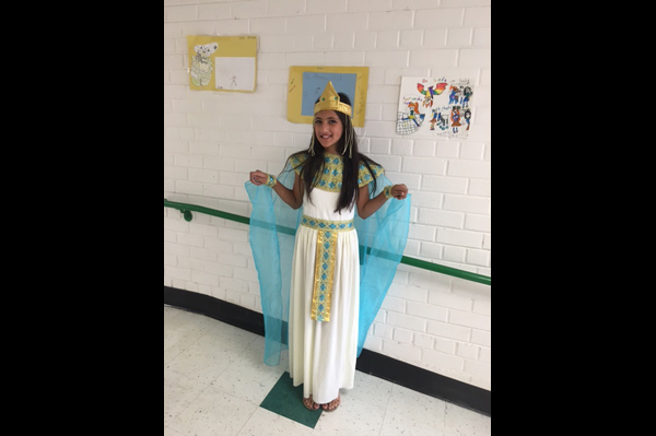 Student dressed in Egyptian princess costume stands in the hallway