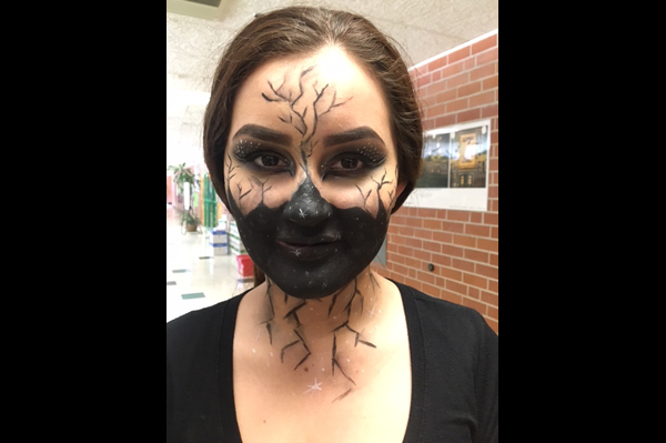 Student with half face painted black in a scary design