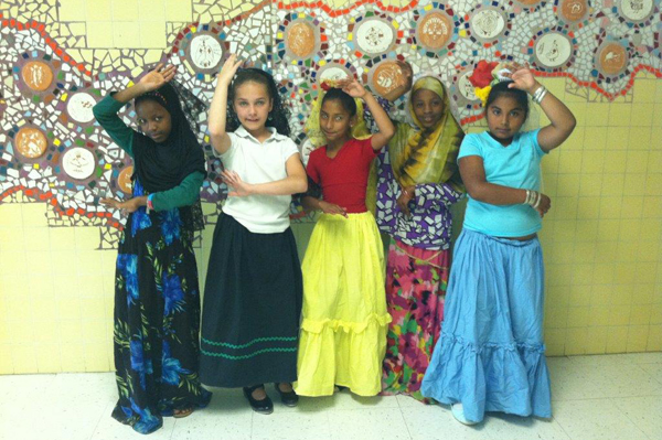 Students dressed in traditional heritage clothing posing