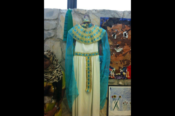 Traditional heritage dress displayed with project next to student 